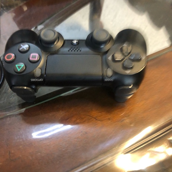 This ps4 pro comes with a controller and controller wall charger.